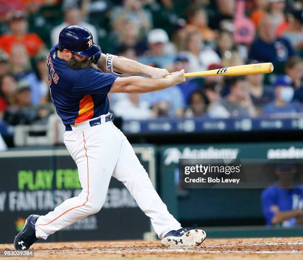 Evan Gattis of the Houston Astros hits a home run in the eighth inning against the Kansas City Royals at Minute Maid Park on June 24, 2018 in...