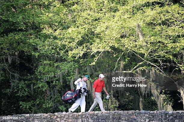 Paul Casey of England and his caddie Christian Donald walk over the Nelson Bridge during a practice round prior to the 2010 Masters Tournament at...