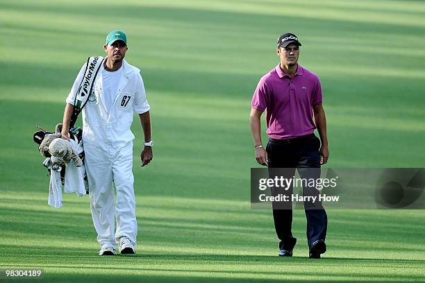 Martin Kaymer of Germany walks down a fairway alongside caddie Justin Grenfell-Hoyle during a practice round prior to the 2010 Masters Tournament at...