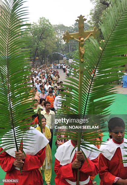 Altar boys hold palm leaves as they participate in Holy Mass at the Saint Mary's Church in Secunderabad, the twin city of Hyderabad, on March 28 on...