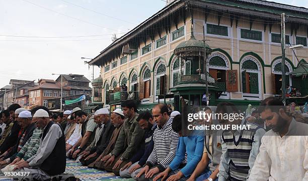 Kashmiri Muslim men pray at shrine to Saint Syed Abdul Qadir Jilani during the annual commemoration of the Sufi saint's death in Srinagar on March...