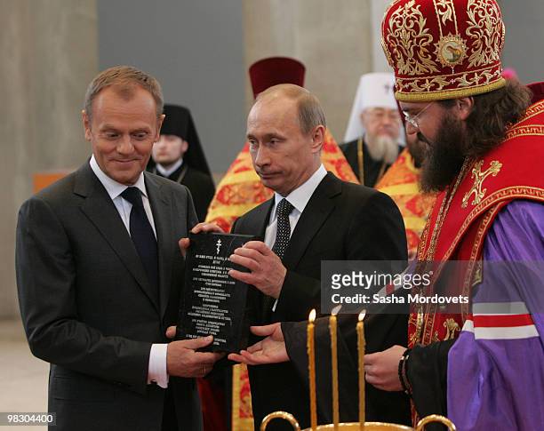 Russian Prime Minister Vladimir Putin and Poland's Prime Minister Donald Tusk visit the construction site of a new Russian Orthodox cathedral for the...