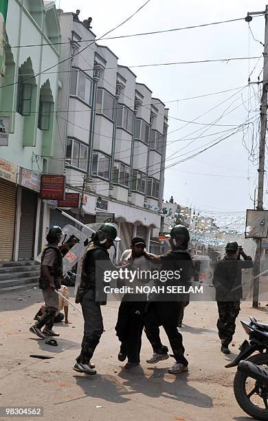 Indian police arrest members of communal mobs pelting each other with stones in the Sha Ali Banda area of the old city of Hyderabad on March 29,...