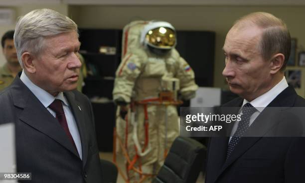 Russia's Prime Minister Vladimir Putin speaks with Head of the Russian Federal Space Agency, Anatoly Perminov during a visit to the Gagarin Cosmonaut...