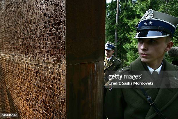 Polish officers stand guard at a memorial site as Russian Prime Minister Vladimir Putin and Poland's Prime Minister Donald Tusk visit a memorial site...