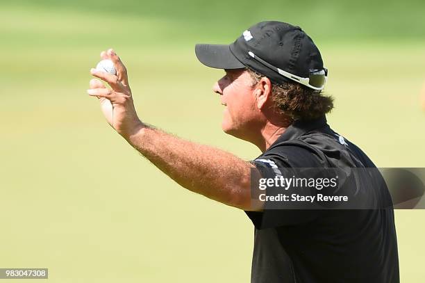 Scott McCarron waves to the crowd on the 18th green during the third and final round of the American Family Championship at University Ridge Golf...