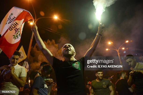 Man waves a flag of the pro-Kurdish Peoples' Democratic Party after the results of the Turkish presidential and parliamentary elections, on June 24,...