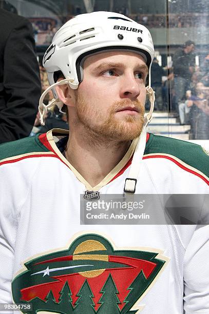 Kyle Brodziak of the Minnesota Wild sits on the bench prior to a game against the Edmonton Oilers at Rexall Place on April 5, 2010 in Edmonton,...