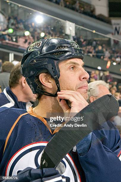 Jason Strudwick of the Edmonton Oilers puts on his helmet before a game against the Minnesota Wild at Rexall Place on April 5, 2010 in Edmonton,...
