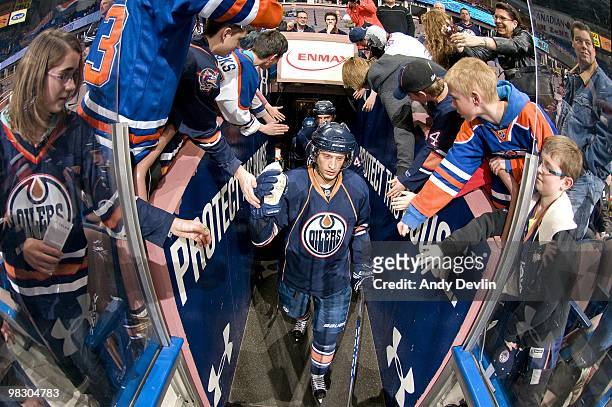 Tom Gilbert of the Edmonton Oilers makes his way towards the ice before a game against the Minnesota Wild at Rexall Place on April 5, 2010 in...