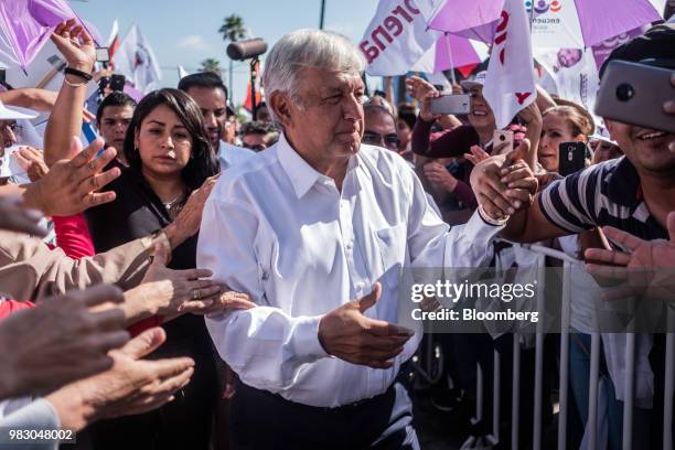 Andres Manuel Lopez Obrador, presidential candidate of the National Regeneration Movement Party , center, greets supporters during the closing...