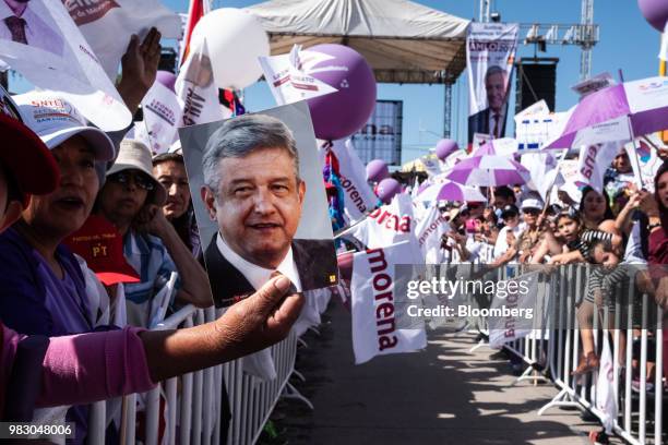 Supporter holds an image of Andres Manuel Lopez Obrador, presidential candidate of the National Regeneration Movement Party , during the closing...