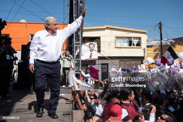 Andres Manuel Lopez Obrador, presidential candidate of the National Regeneration Movement Party , left, waves to supporters during the closing...