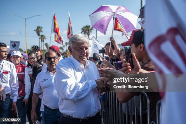 Andres Manuel Lopez Obrador, presidential candidate of the National Regeneration Movement Party , center, greets supporters during the closing...