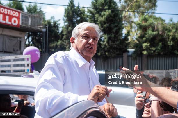 Andres Manuel Lopez Obrador, presidential candidate of the National Regeneration Movement Party , greets supporters after speaking during the closing...