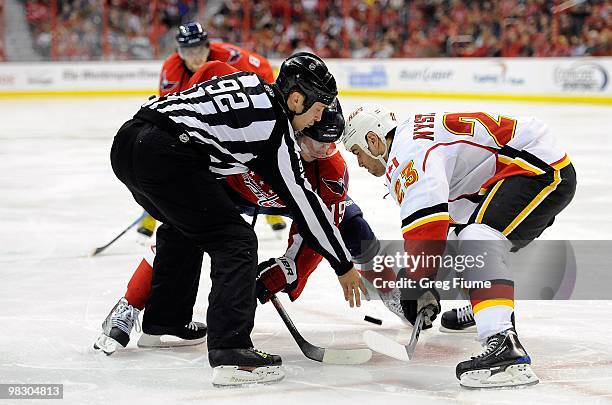 Nicklas Backstrom of the Washington Capitals takes a face off against Eric Nystrom the Calgary Flames at the Verizon Center on March 28, 2010 in...