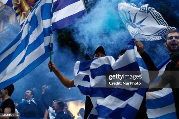 People wave Greek flags as they demonstrate against the agreement between Greece and Macedonia for the new name, in Thessaloniki on June 24, 2018....