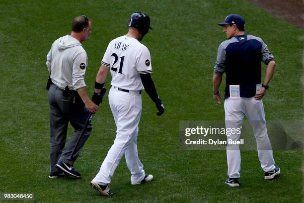 Travis Shaw of the Milwaukee Brewers leaves the game in the third inning against the St. Louis Cardinals at Miller Park on June 24, 2018 in...