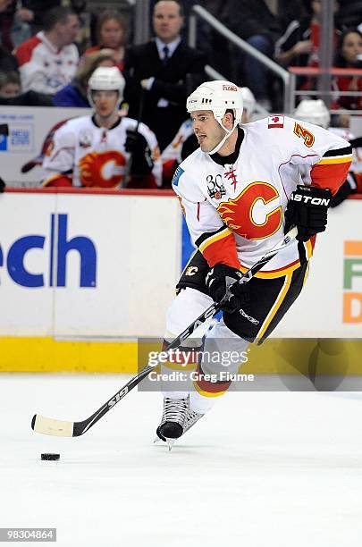 Ian White of the Calgary Flames handles the puck against the Washington Capitals at the Verizon Center on March 28, 2010 in Washington, DC.