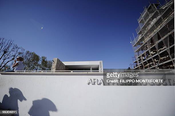 Woman sits by the Ara Pacis museum on April 7, 2010 in Rome. Rome's mayor Gianni Alemanno, who called the building in 2006 "a scar in the heart of...