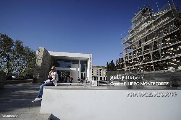 Woman sits by the Ara Pacis museum on April 7, 2010 in Rome. Rome's mayor Gianni Alemanno, who called the building in 2006 "a scar in the heart of...