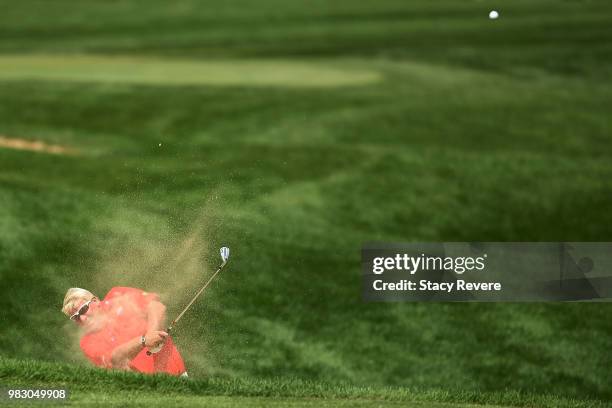 John Daly hits his second shot on the 18th hole during the third and final round of the American Family Championship at University Ridge Golf Course...