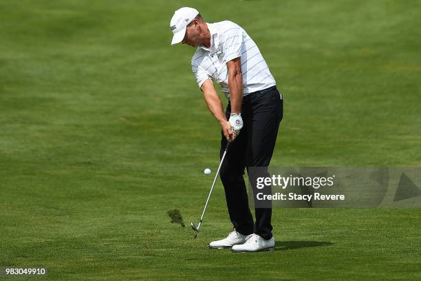 Steve Stricker hits his second shot on the 18th hole during the third and final round of the American Family Championship at University Ridge Golf...