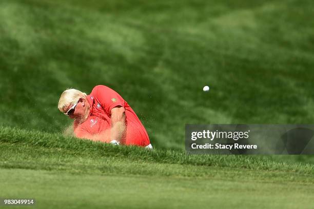 John Daly hits his second shot on the 18th hole during the third and final round of the American Family Championship at University Ridge Golf Course...