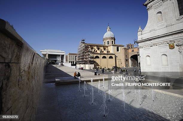 People sit by the Ara Pacis museum on April 7, 2010 in Rome. Rome's mayor Gianni Alemanno, who called the building in 2006 "a scar in the heart of...