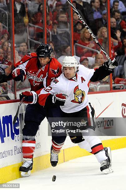 Jason Chimera of the Washington Capitals is checked by Mike Fisher of the Ottawa Senators at the Verizon Center on March 30, 2010 in Washington, DC.