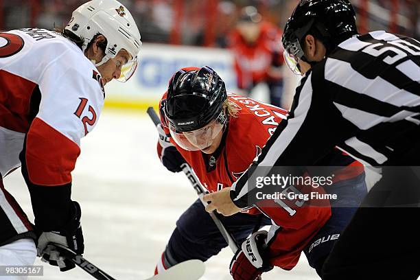 Nicklas Backstrom of the Washington Capitals takes a face off against Mike Fisher of the Ottawa Senators at the Verizon Center on March 30, 2010 in...