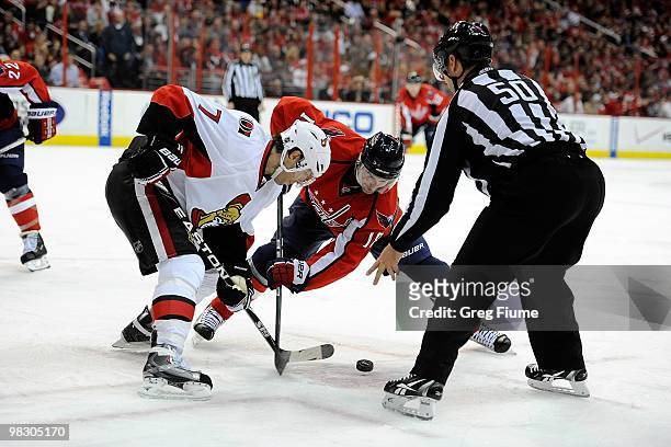 Eric Belanger of the Washington Capitals takes a face off against Matt Cullen of the Ottawa Senators at the Verizon Center on March 30, 2010 in...