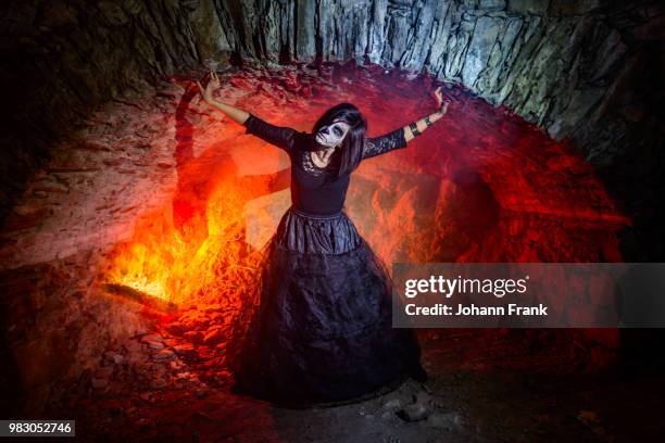 girl from hell - cave fire stock pictures, royalty-free photos & images