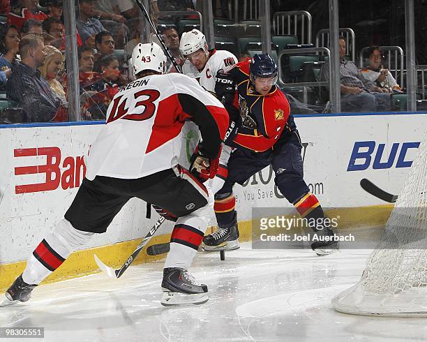 Clay Wilson of the Florida Panthers battles behind th enet for the puck with Daniel Alfredsson and Peter Regin of the Ottawa Senators on April 6,...