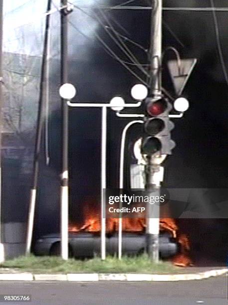 Russian NTV channel television grab shows a burning car near a police station in Karabulak on April 5, 2010. A suicide bomber triggered his...