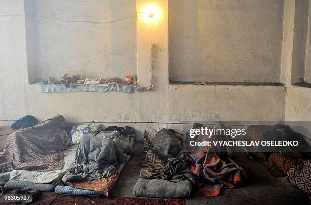 Homeless people rest at a shelter in the Kyrgyz capital of Bishkek on February 15, 2010. The city authorities allow homeless people to occupy a...