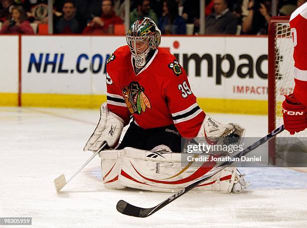 Christobal Huet of the Chicago Blackhawks makes a glove save against the Detroit Red Wings at the United Center on March 7, 2010 in Chicago,...