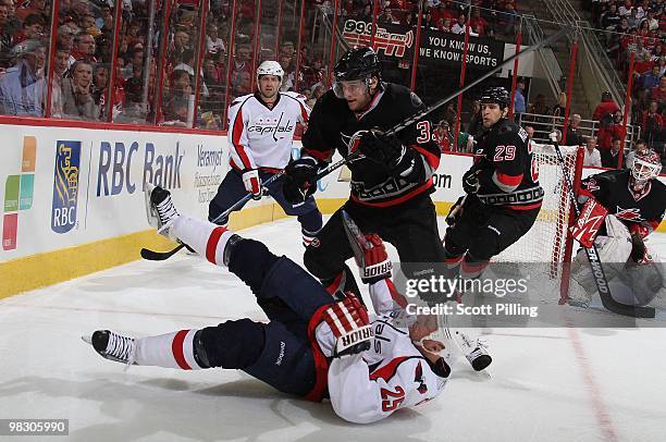 Bryan Rodney of the Carolina Hurricanes puts Jason Chimera of the Washington Capitals onto the ice during their NHL game on March 25, 2010 at the RBC...