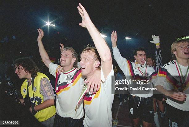 Rudi Voeller, Andreas Brehme, Juergen Kohler, Bodo Illgner and Juergen Klinsmann of Germany celebrate their defeat of Argentina in the 1990 FIFA...