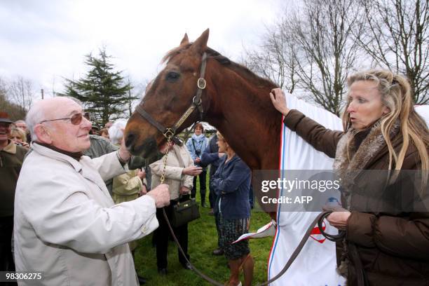 French former horse rider Michel-Marcel Gougeon poses beside Ourasi , a retired French champion racing trotter, on April 07, 2010 in Bayeux in the...