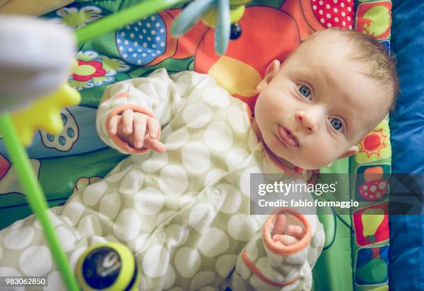 baby with blue eyes playing with toys - baby blue eyes stock pictures, royalty-free photos & images