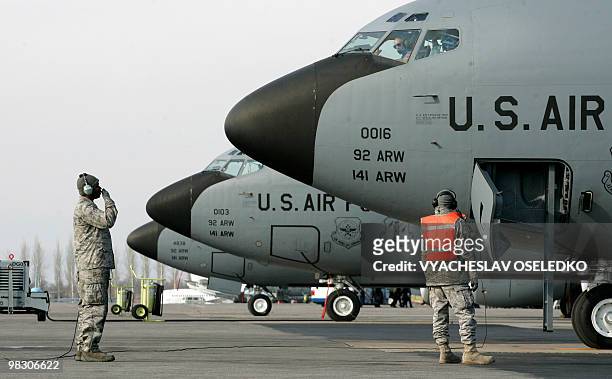 Soldiers perform their daily routines on the runway of the Manas airbase, 30 km outside Bishkek, on February 12, 2009. US and Russian officials on...