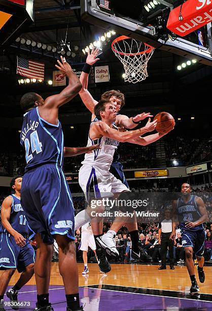 Beno Udrih of the Sacramento Kings goes to the basket against Paul Millsap and Kyrylo Fesenko of the Utah Jazz during the game on February 26, 2010...