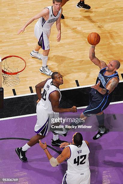 Carlos Boozer of the Utah Jazz puts up a shot over Joey Dorsey of the Sacramento Kings during the game on February 26, 2010 at Arco Arena in...