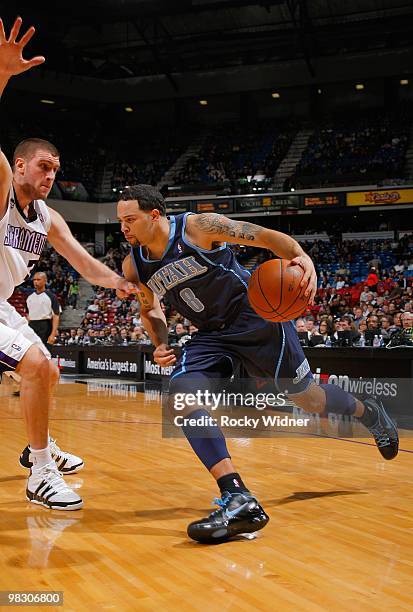 Deron Williams of the Utah Jazz drives against Spencer Hawes of the Sacramento Kings during the game on February 26, 2010 at Arco Arena in...