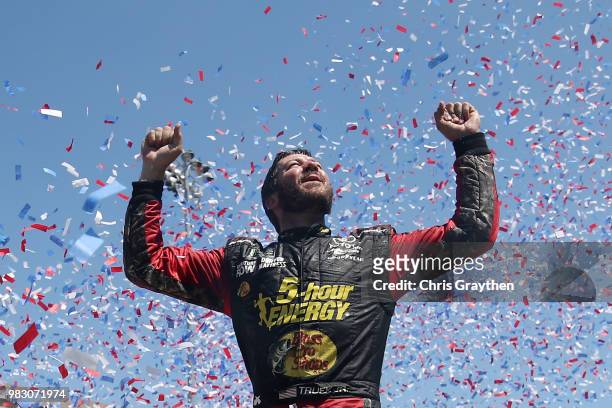 Martin Truex Jr., driver of the 5-hour ENERGY/Bass Pro Shops Toyota, celebrates in victory lane after winning the Monster Energy NASCAR Cup Series...