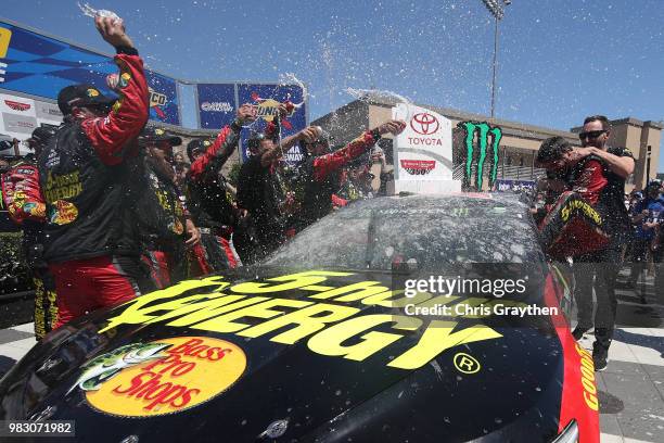 Martin Truex Jr., driver of the 5-hour ENERGY/Bass Pro Shops Toyota, celebrates in victory lane after winning the Monster Energy NASCAR Cup Series...