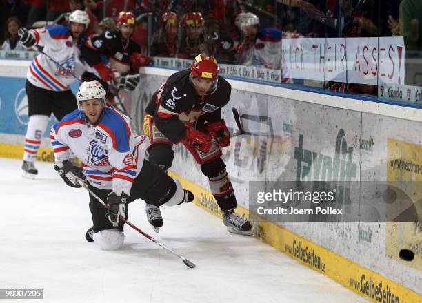 Nikolaus Mondt of Hannover and Bjoern Barta of Nuernberg battle for the puck during the fifth DEL quarter final play-off game between Hannover...