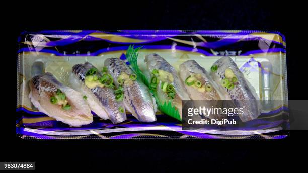 horse mackerel sushi in disposable plastic tray on black background - trachurus stock pictures, royalty-free photos & images