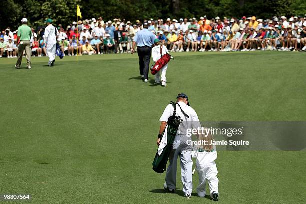 Jerry Kelly; Steve Stricker and Scott Verplank walk with their caddies during the Par 3 Contest prior to the 2010 Masters Tournament at Augusta...